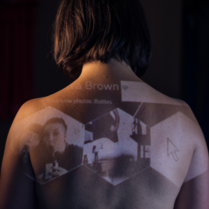 A photo of a woman's back. On it are projected images of her and others.