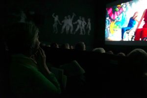 the audience is watching a film screening.