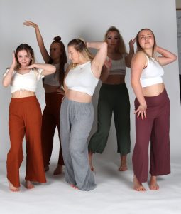 the five women are all wearing leggings and white tops on a white background