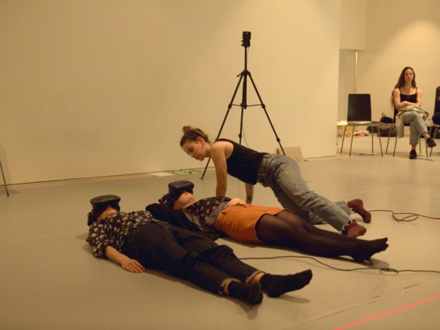 Two people laying on the floor in a room.