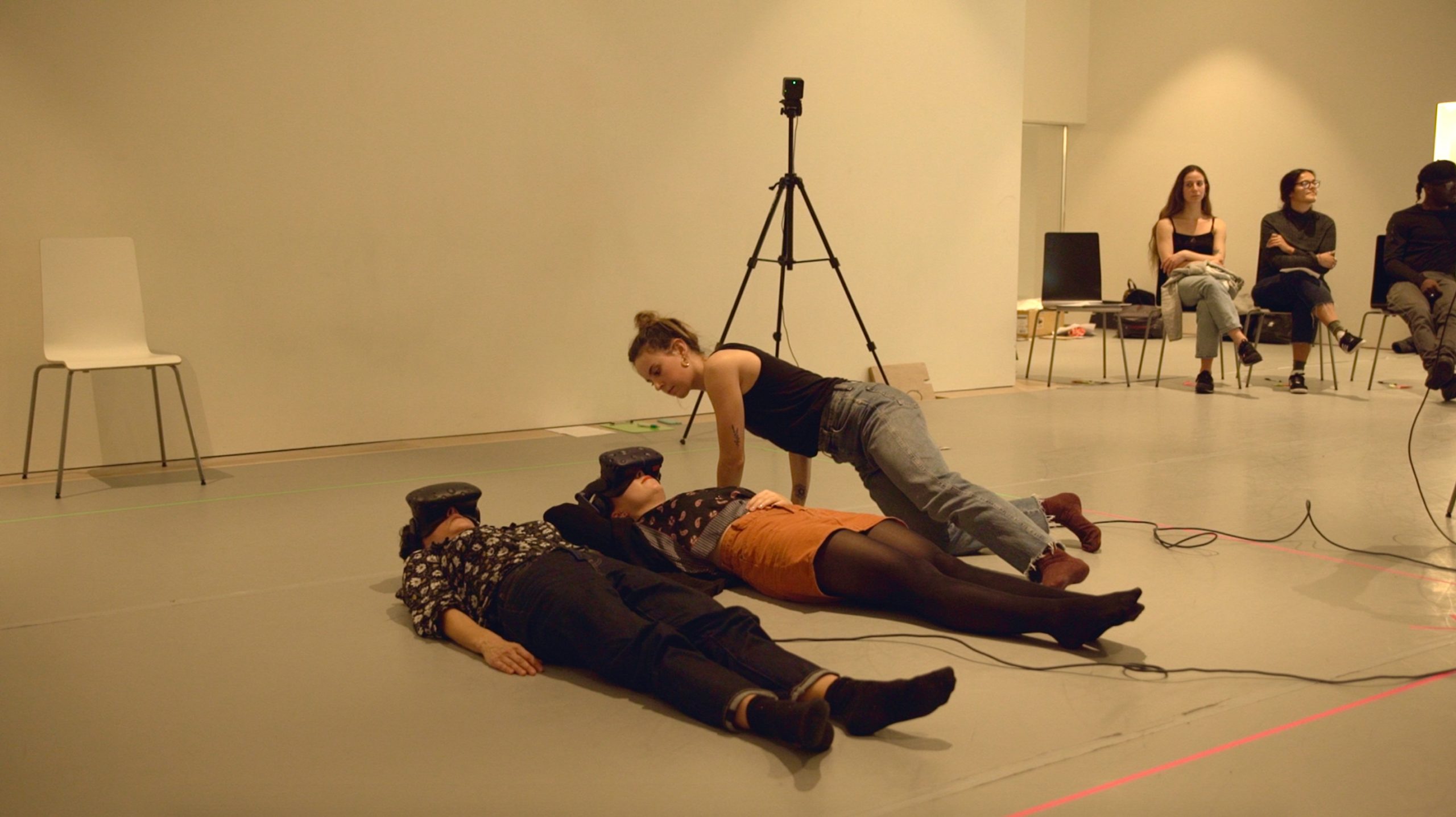 Two people laying on the floor in a room.