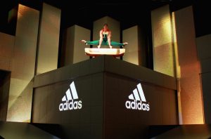 an athlete is poison on top of a box with adidas logos at an event