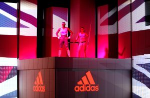 two people on stage on Adidas podium.
