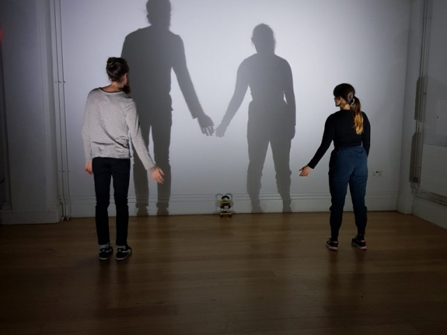 Two people shadowed on a wall